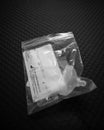 Disposal of Covid 19 saliva test kit in a plastic bag after use