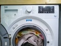 Free-standing Beko washing machine loaded with comforter.