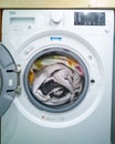 Free-standing Beko washing machine loaded with comforter.