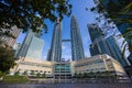 Kuala Lumpur, Malaysia - August 13, 2022: View of the Twin Towers through the palm trees of KLCC Park. Urban oasis with water