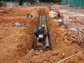 Underground sewerage pipe installed by construction workers at the construction site. Royalty Free Stock Photo