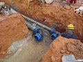 Underground sewerage pipe installed by construction workers at the construction site. Royalty Free Stock Photo