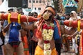 Hindu devotee carrying a heavy structure as burden during Thaipusam Festival at Batu Caves