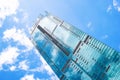 Kuala Lumpur, Malaysia - February 21, 2020: Bottom view on skyscraper on a background of blue sky with reflection of clouds. Royalty Free Stock Photo