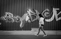 Girl walking and graffit on the background