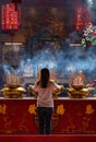 Woman Praying In A Chinese Temple In Kuala Lumpur, Malaysia