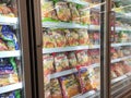 Frozen food displayed on the rack inside the large chiller in the supermarket.