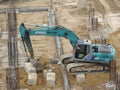 Heavy construction machines doing building foundation works at the construction site. Royalty Free Stock Photo