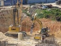 Heavy construction machines doing building foundation works at the construction site. Royalty Free Stock Photo