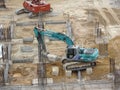 Heavy construction machines doing building foundation works at the construction site. Royalty Free Stock Photo