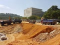 Heavy machinery doing the earthwork site clearing at the construction site.