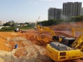 Heavy machinery doing the earthwork site clearing at the construction site.