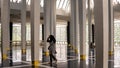 A hijab girl walking in the National Mosque or Masjid Negara in Kuala Lumpur. The mosque have beautiful interior and Islamic