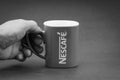 Promotional red Nescafe mug on Black and White