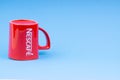 Promotional red Nescafe mug on blue background