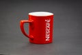 Promotional red Nescafe mug on dark background