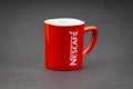 Promotional red Nescafe mug on dark background