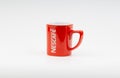 Promotional red Nescafe mug on white background