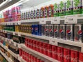 Soft drinks in cans are displayed on a shelf for sale in a large supermarket. Royalty Free Stock Photo