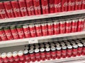 Soft drinks in cans are displayed on a shelf for sale in a large supermarket. Royalty Free Stock Photo