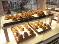 Various types of breads are displayed for sale inside the bakery display rack. Royalty Free Stock Photo