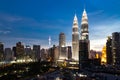 KUALA LUMPUR, MALAYSIA - JULY 23, 2016: View of the Petronas Twin Towers and KL Tower at KLCC City Center during dusk hour. The Royalty Free Stock Photo