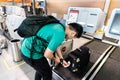 KUALA LUMPUR, MALAYSIA JUNE 7, 2019: Person performing self check-in of luggage at airport luggage check-in facility