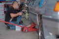 Tyre change on the car in a workshop by a mechanic Royalty Free Stock Photo