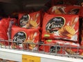 Variety of biscuits in good and interesting packaging and displayed on the racks inside the shop.