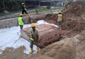 Underground drainage manhole under construction by construction workers at the construction site. Royalty Free Stock Photo