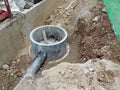 Underground drainage manhole under construction by construction workers at the construction site. Royalty Free Stock Photo