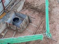 Underground drainage manhole under construction by construction workers at the construction site. Royalty Free Stock Photo