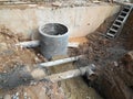 Underground drainage manhole under construction by construction workers at the construction site. Royalty Free Stock Photo