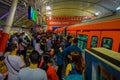 Kuala Lumpur, Malaysia - March 9, 2017: Very busy train station in the city, with crowds of commuters waiting for their Royalty Free Stock Photo