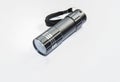 Black metallic with white strips mini flashlight or torch on white background Royalty Free Stock Photo