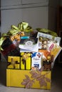 Hamper with various products wrapped in gold colour for Hari Raya Aidilfitri celebration.