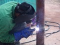 Construction workers welding pipes at the construction site.