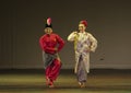 Man and women performing Malaysia traditional dance