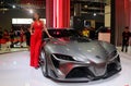 Model posed with Toyota FT-1 concept car produced by Toyota at Toyota booth during