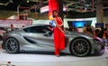 Model posed with Toyota FT-1 concept car produced by Toyota at Toyota booth during