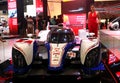 Model posed with Toyota TS030 hybrid racing car produced by Toyota at Toyota booth