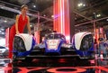 Model posed with Toyota TS030 hybrid racing car produced by Toyota at Toyota booth