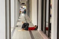 A homeless man lying on the pavement on the streets of the city of Kuala Lumpur Royalty Free Stock Photo