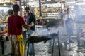 Malaysian men cook for the street restaurant on tourist district