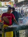 Malaysian men cook for the street restaurant on tourist district
