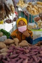 Woman seller wearing face mask at the local ingredients fresh food stall