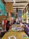 A worker of Natural Batik Village packed visitors` painting.