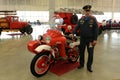 The officer of the Ministry of Emergency Situations at the fireman of the Soviet motorcycle M-63 `Ural`