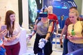 KUBINKA, RUSSIA, AUG.24, 2018: Young girl in exosuit and virtual reality glasses is trying to operate space robot on a computer si Royalty Free Stock Photo