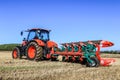 Kubota M7-173 ploughing on stubble in crop field Royalty Free Stock Photo